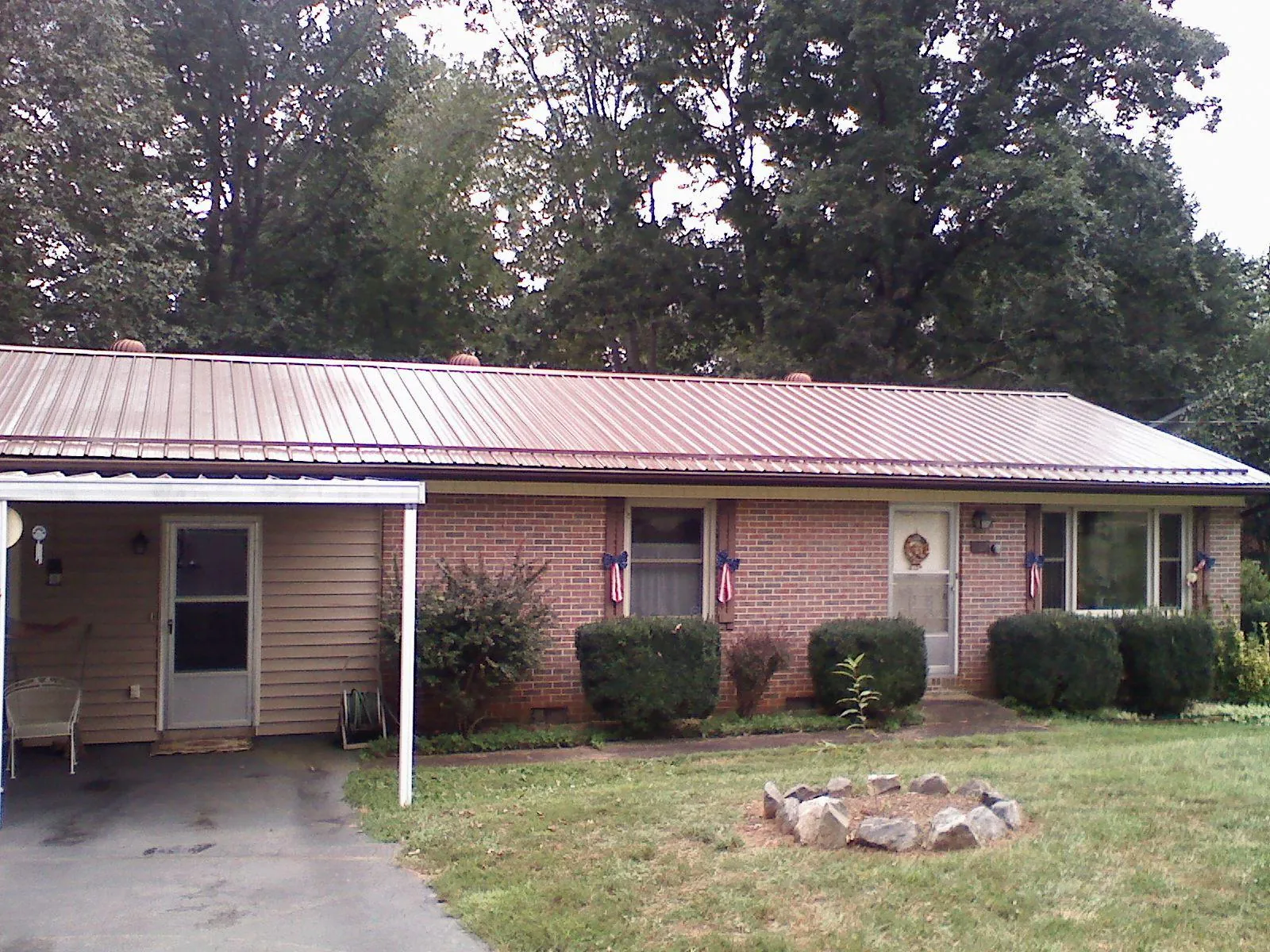 Bronze metal roof and carport on a brick ranch home — Roof Repair work by our crew in Marlow
